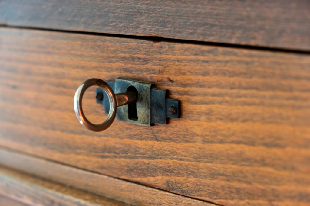 Secret, mystery concept. Close up view of a retro key on an old fashioned keyhole